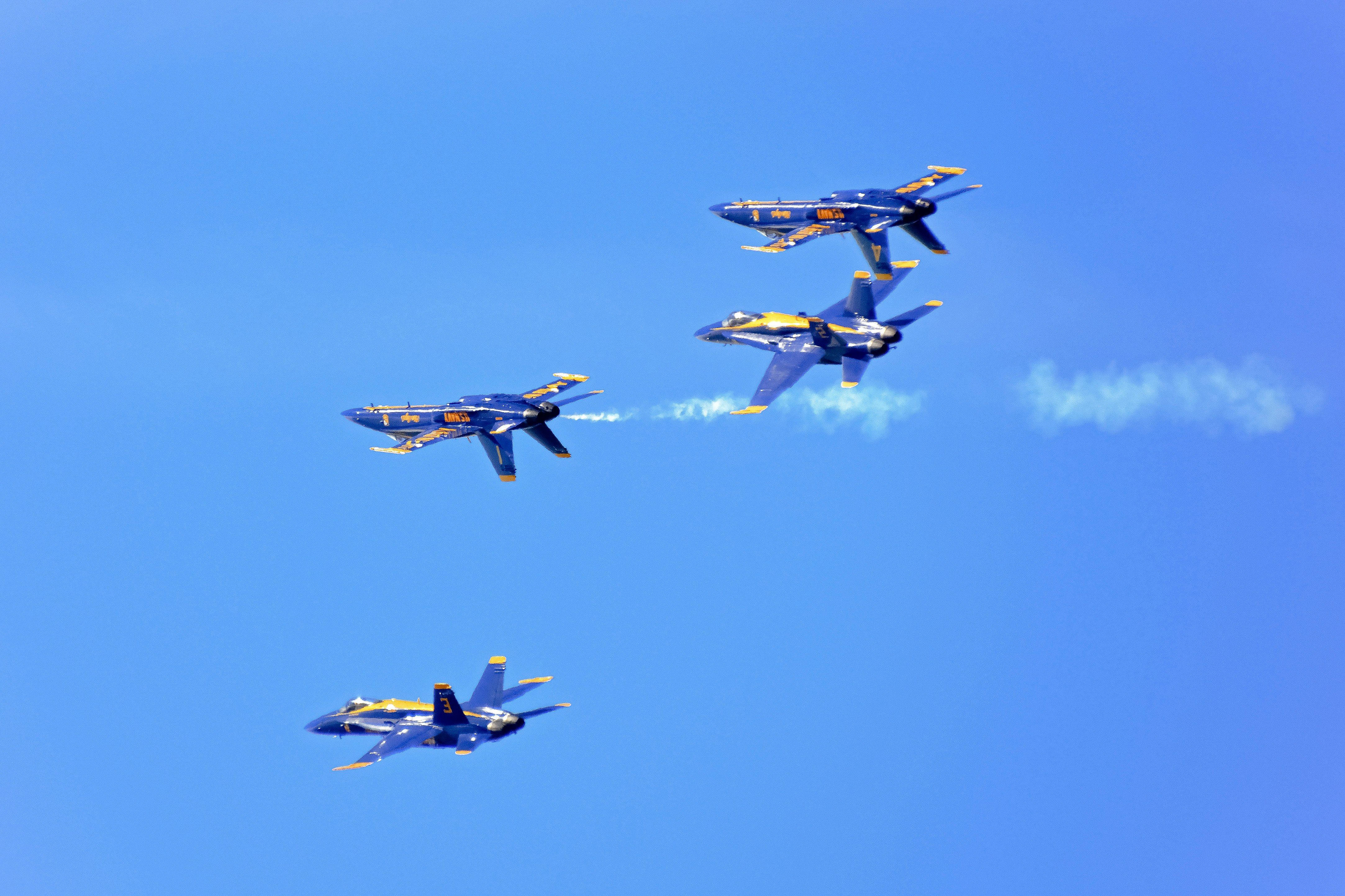 four fighter planes in mid air during daytime
